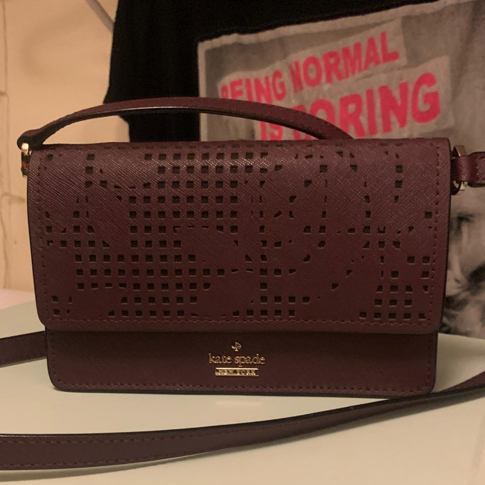 kate spade burgundy perforated leather crossbody with gold logo